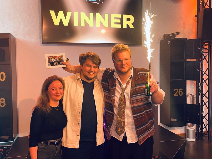 Drei Freunde lachen als Quizloft Gewinner in die Kamera